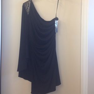 One shoulder black dress.