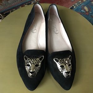 Black suede flats with gold leopard emblems