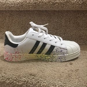 All white and black adidas with splattered paint