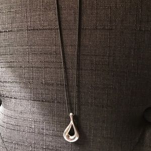 Tiffany & Co. open tear drop on a silk rope.