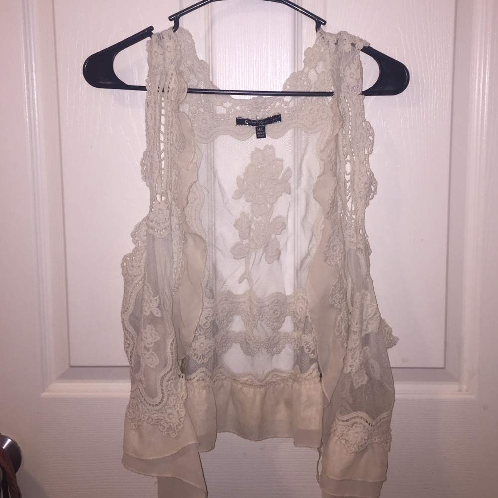 vest with floral print appliqués, lace and sheer.