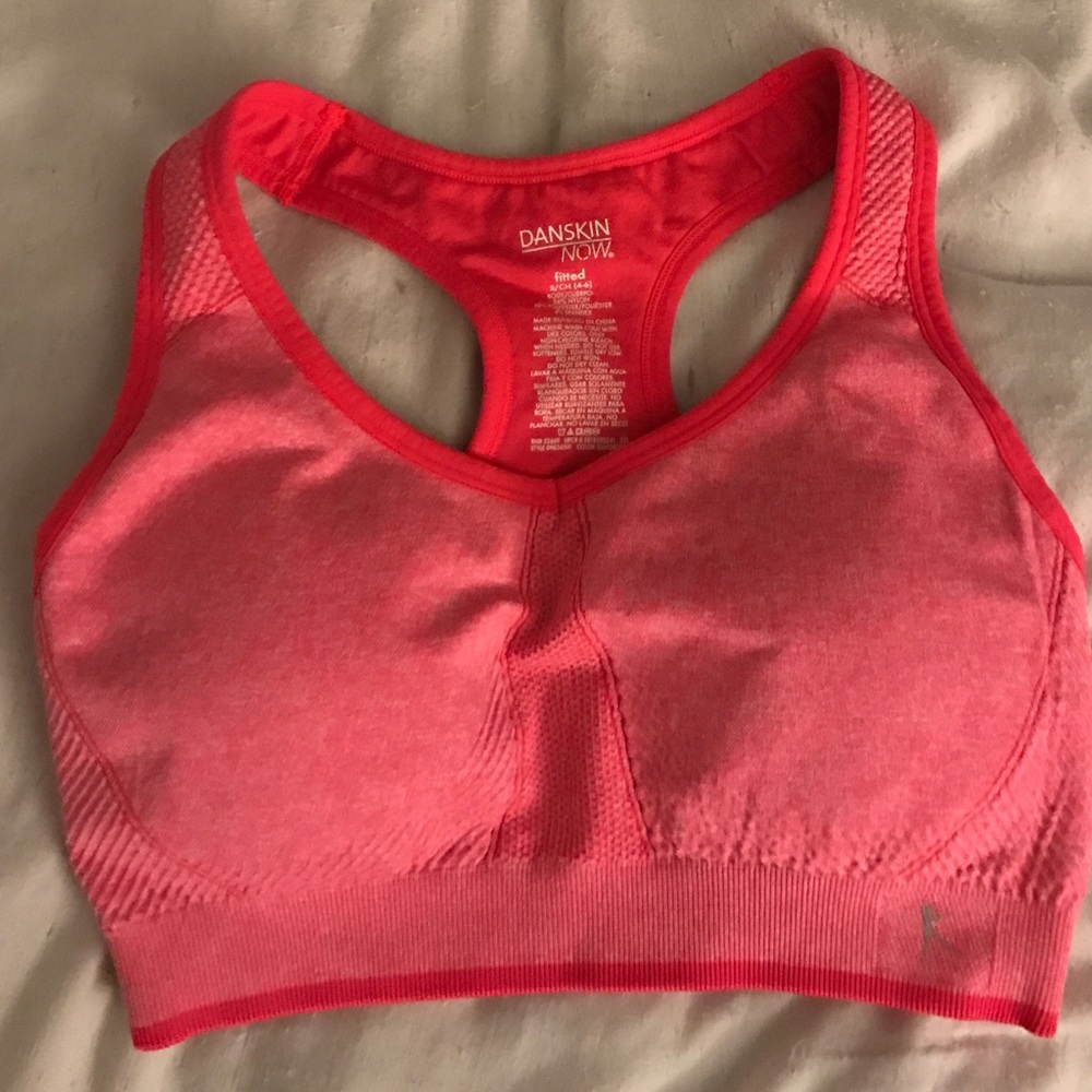 Bright coral color sports bra.