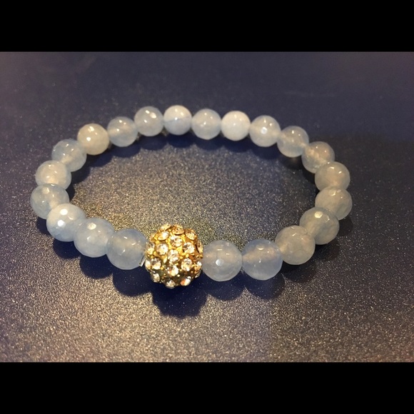 The Limited Jewelry - Light blue, elastic bracelet. Crystal/ gold ball