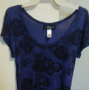 A blue short sleeved shirt made by Abbey Dawn.