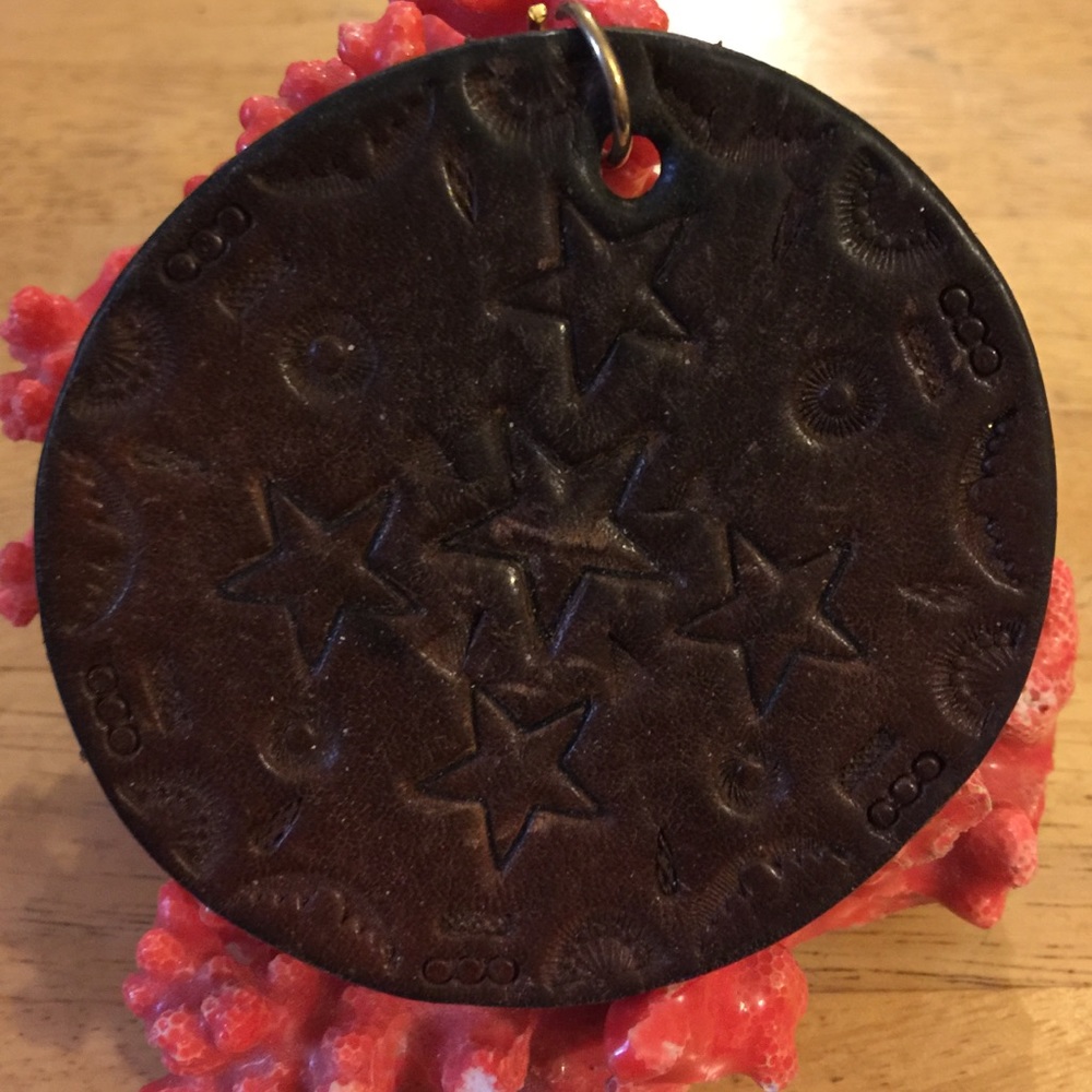 NA engraved leather pendent