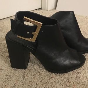 Black open toe ankle boot with gold buckle