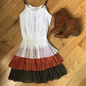 Tiered white, red orange, brown dress.