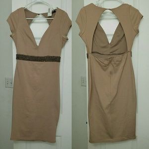Nude form fitting open back dress