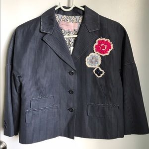 Pinstriped navy blue blazer with flower detail.