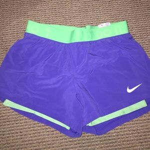 Purple Nike running shorts w/ green spandex insert