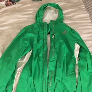 Green and white north face rain jacket
