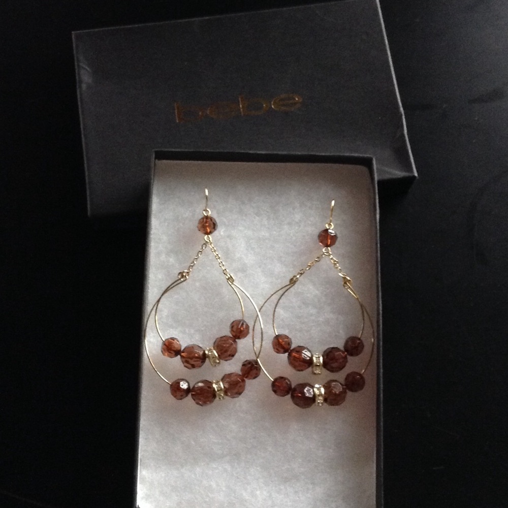 Bebe dangle gold earrings.