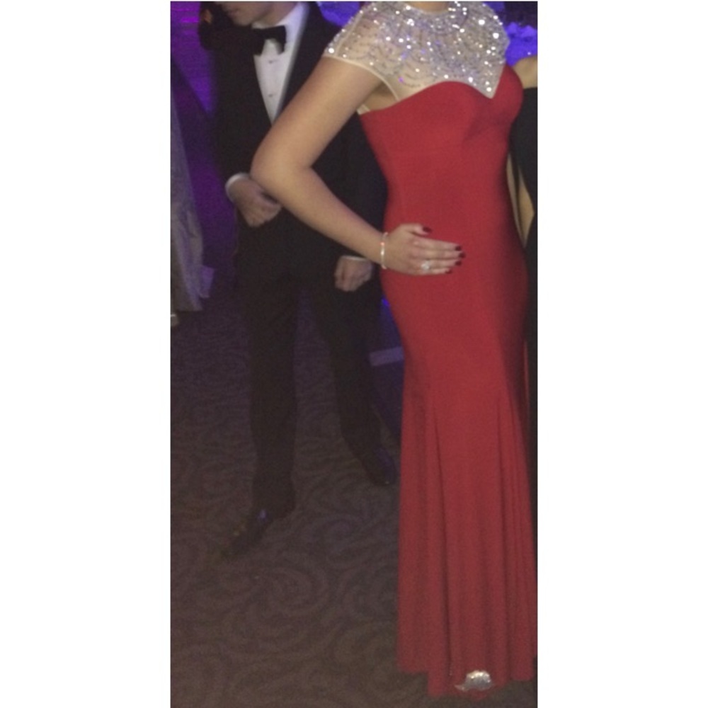 Red fitted evening gown with beading at neckline