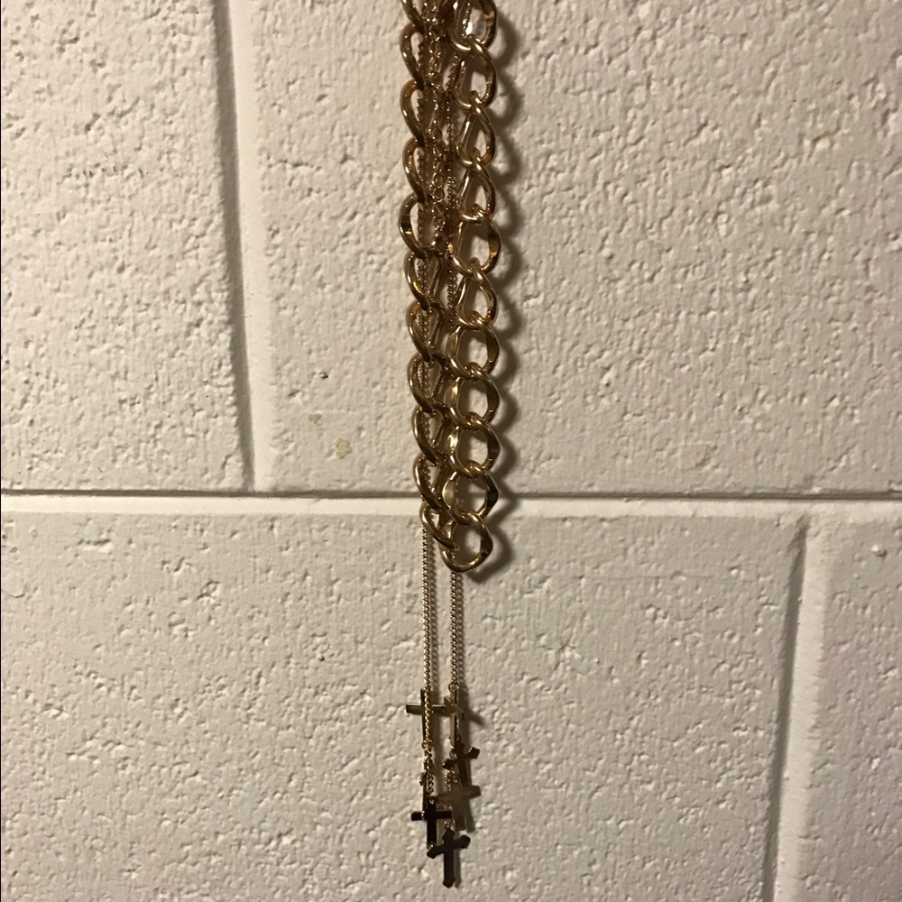 Gold chain with additional cross necklace attached