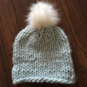 Baby blue beanie with white fur ball