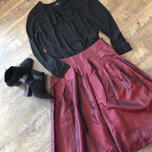 Burgundy taffeta high-waist skirt.