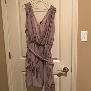 Sleeveless tan and navy dress.