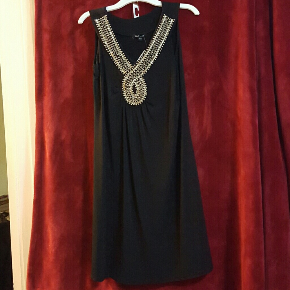 Black dress with gold sequin accents.