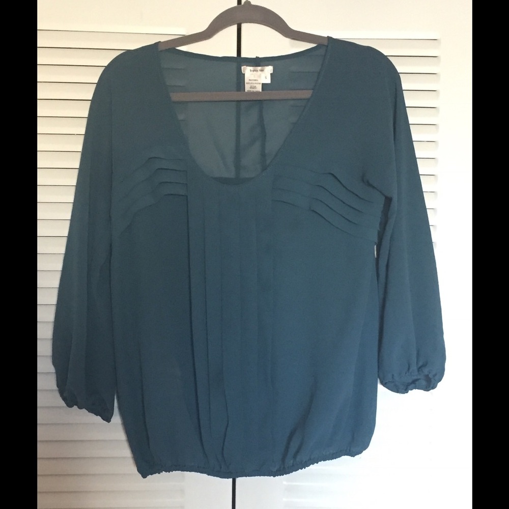Sheer teal long sleeved detailed top.
