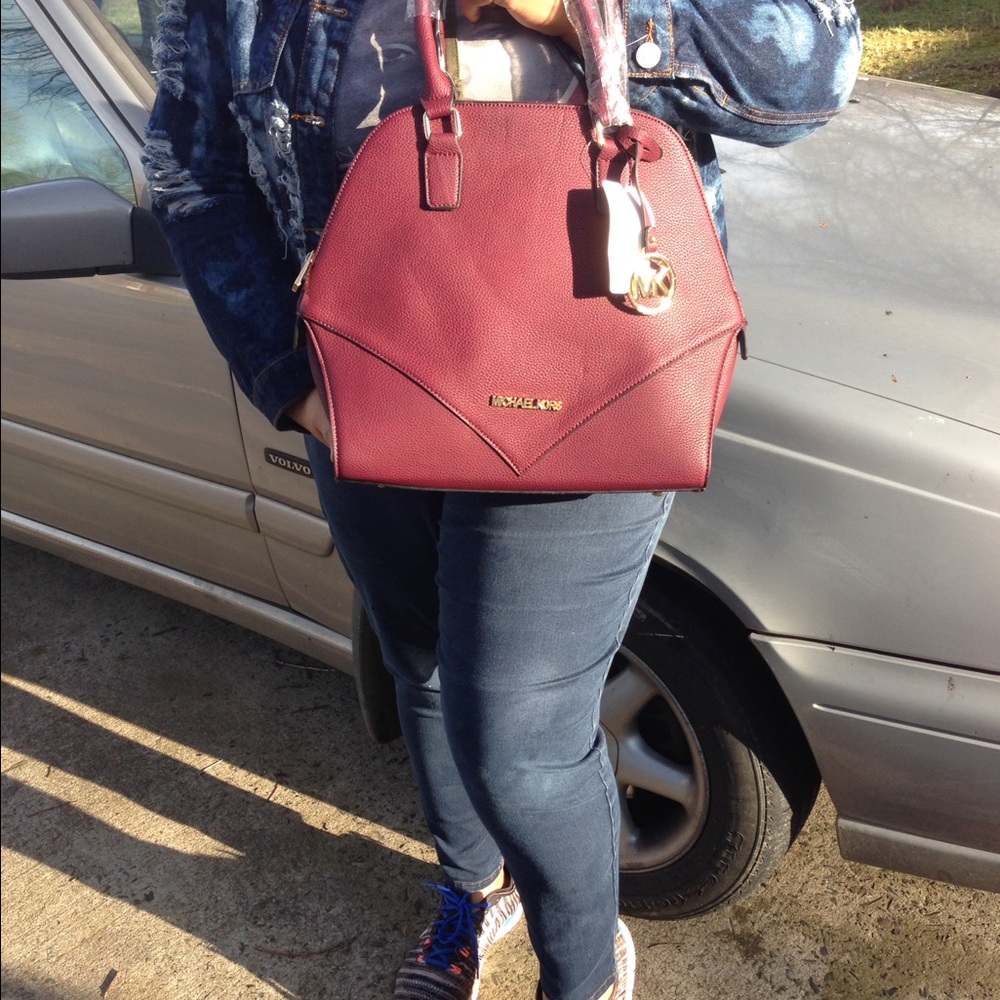 Purple color with a detachable shoulder strap.