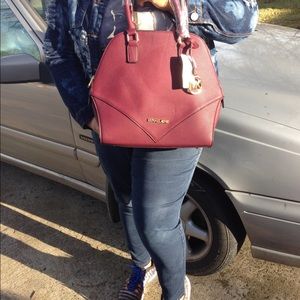 Purple color with a detachable shoulder strap.