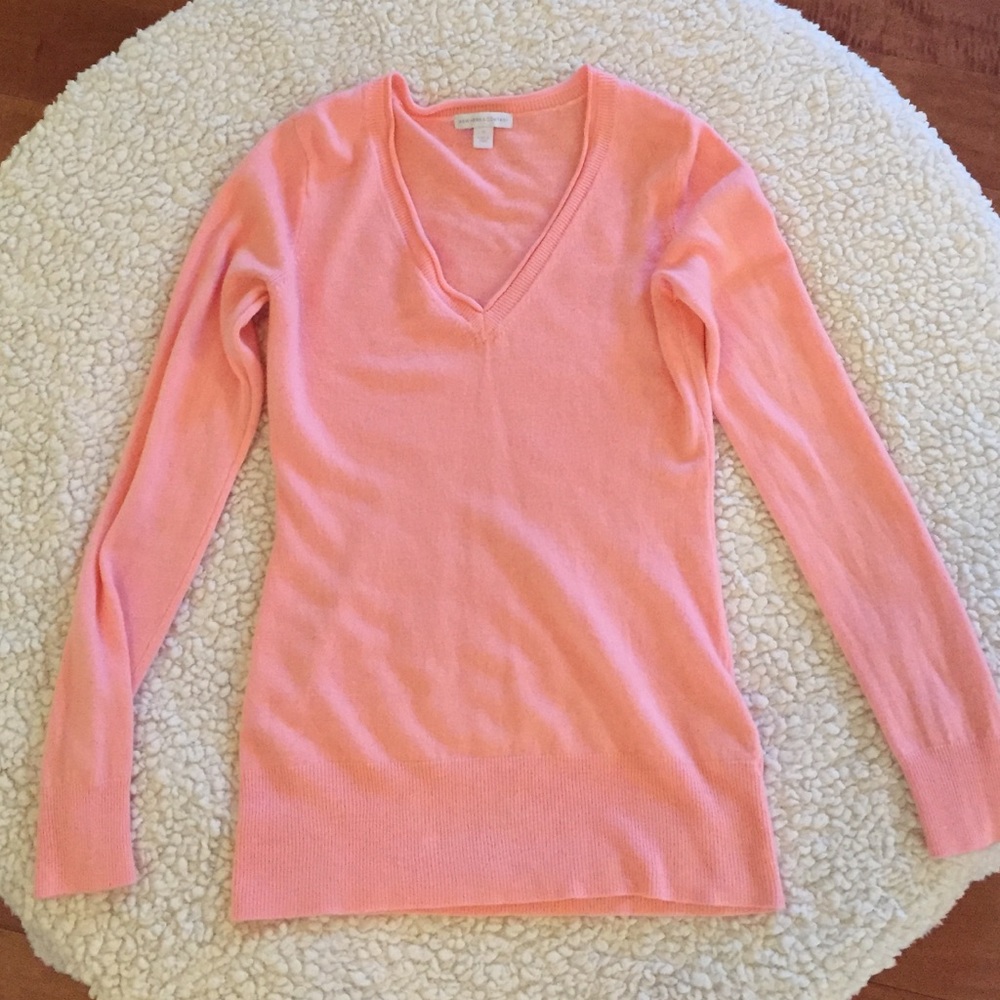 Peach/Pink colored sweater.