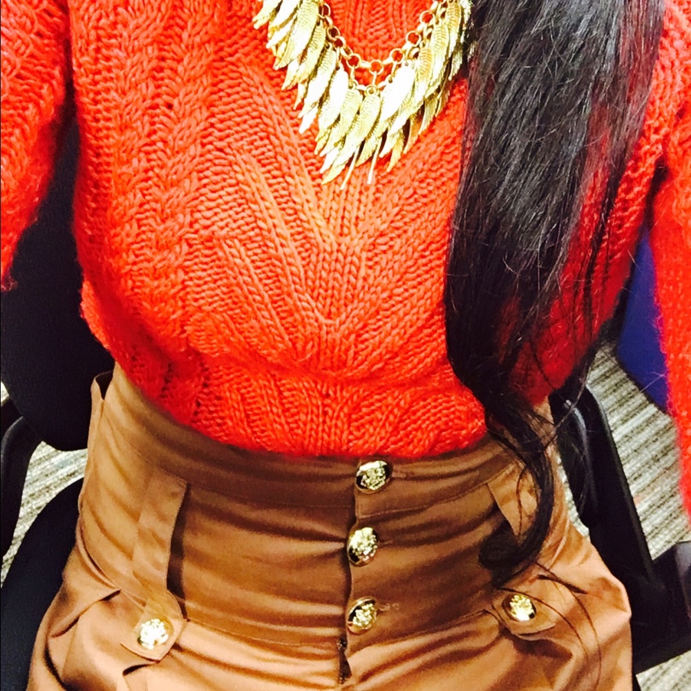 Red cardigan and tan skirt