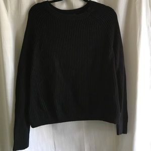 Black cable knit sweater, side slit, knit details.