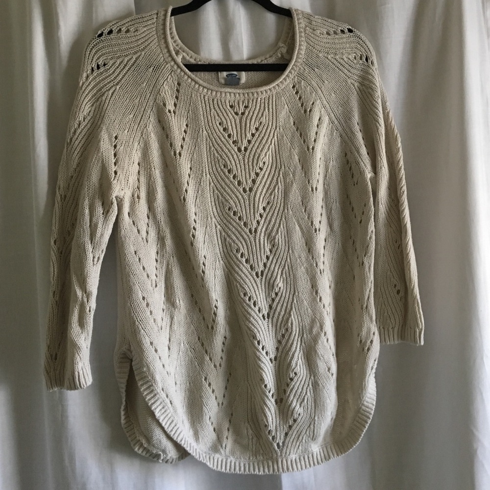 Cable knit light pink sweater.