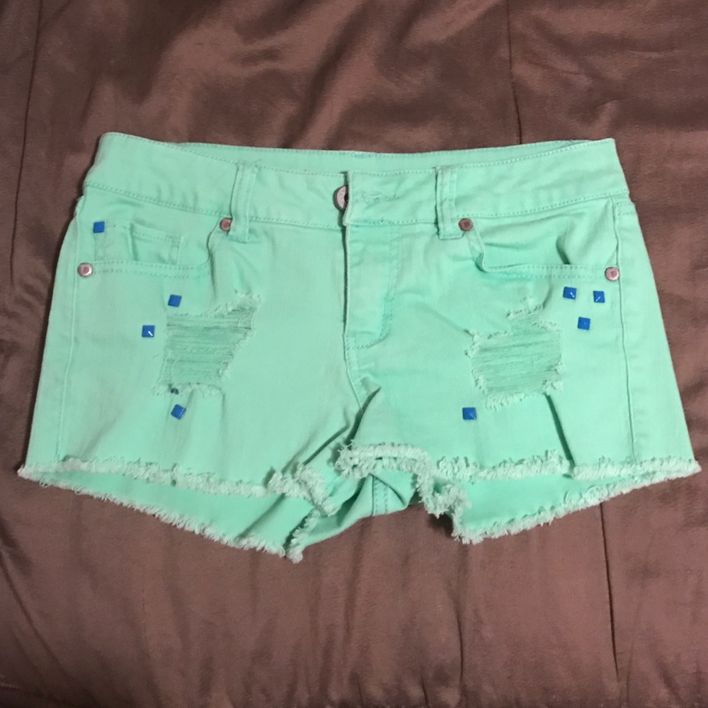 Distressed mint green denim shorts