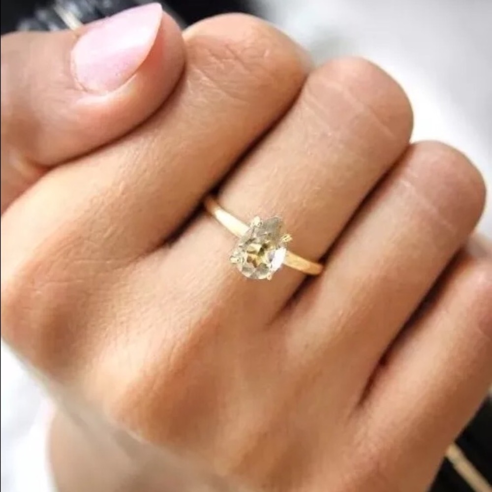 Teardrop gold ring with white quartz stone