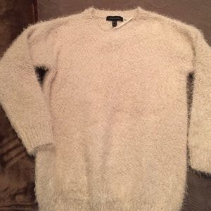 A cream fuzzy sweater.