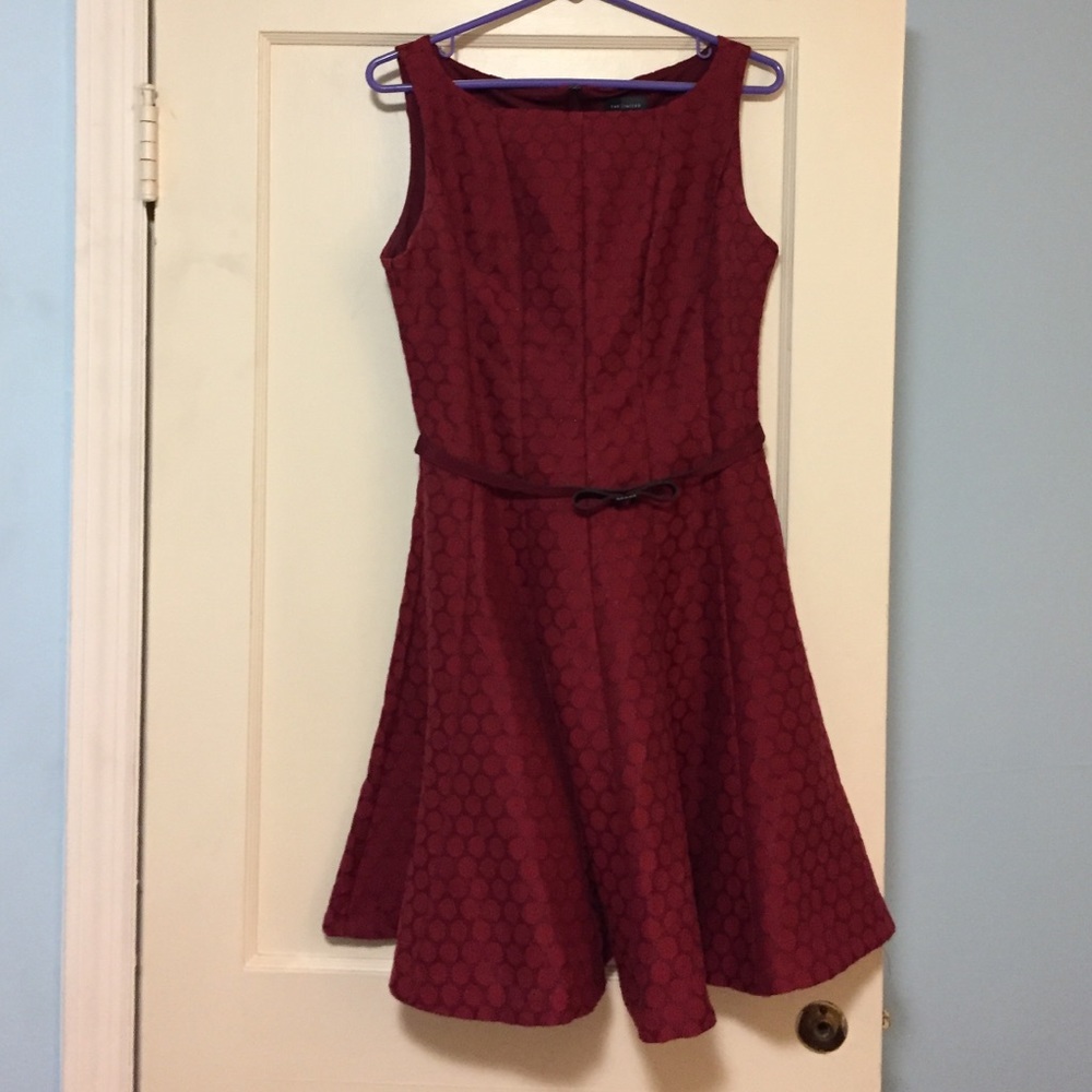 Red A-line dress with polka dots and accent belt.