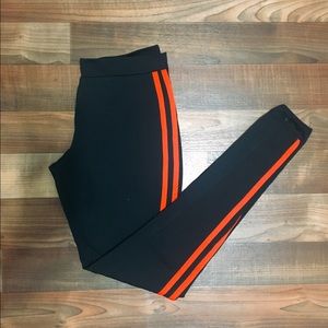 Black athletic leggings with red stripe