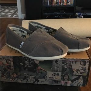 Toms Ash Gray canvas slip on shoes.