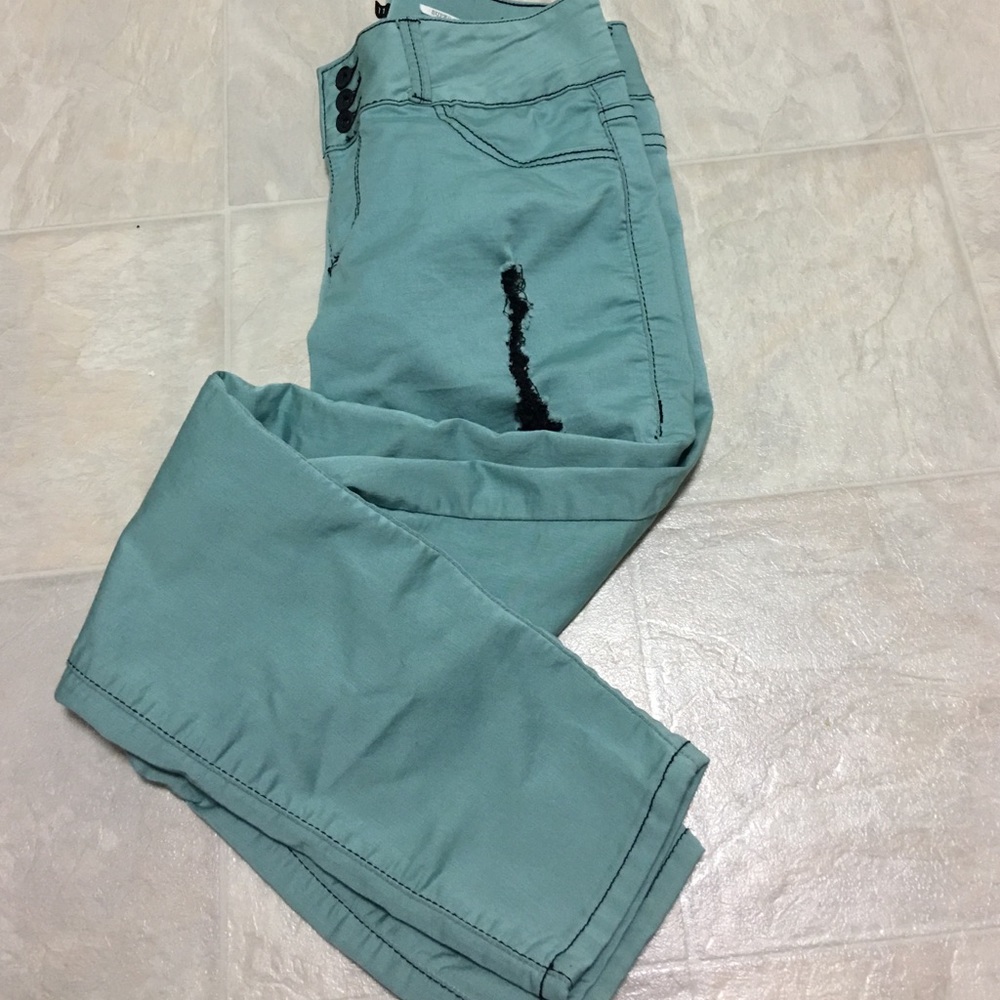 Ripped mint green skinny jeans