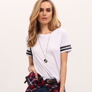 white t shirt with black stripes on sleeve