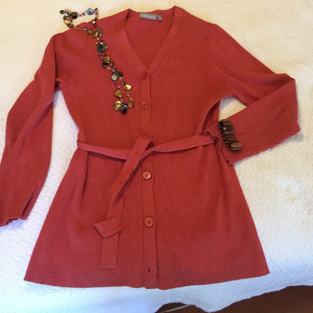 Rust colored v-neck long length cardigan.