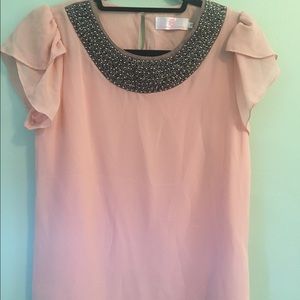 Pretty pink blouse with beaded neckline.