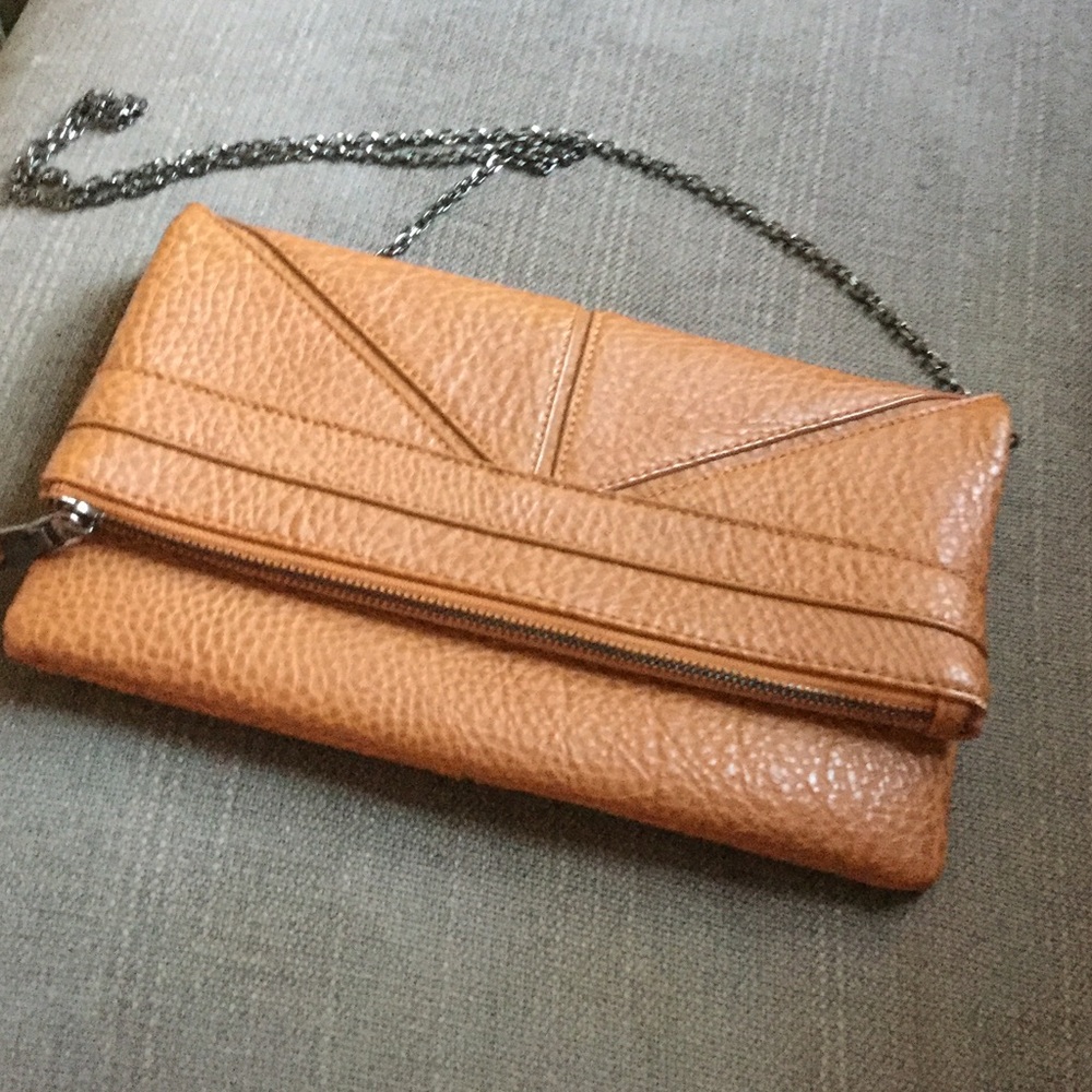 A brown cross body bag with a black chain