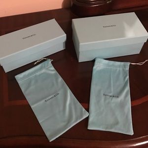Two Tiffany boxes and bags for sunglasses .