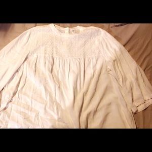 Loose fitting boat-neck top.