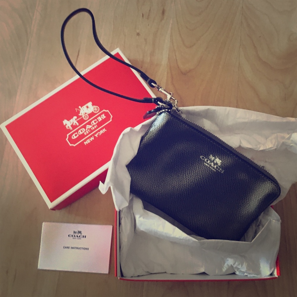 ! NWT Silver leather Coach wristlet.