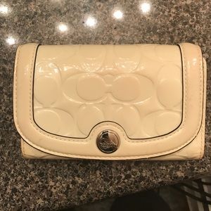 White trifold coach wallet