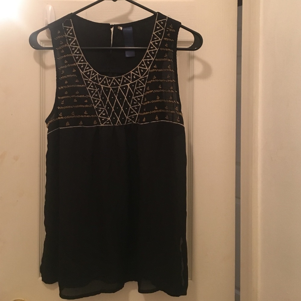 Black sleeveless too w/ gold and white detailing