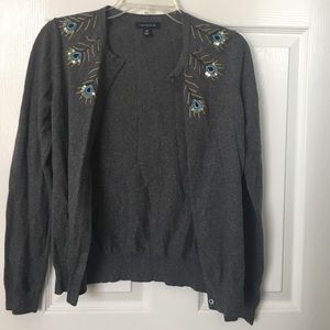 Grey cardigan with peacock feather outlines.