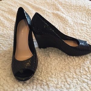 Black wedge open-toe shoes.