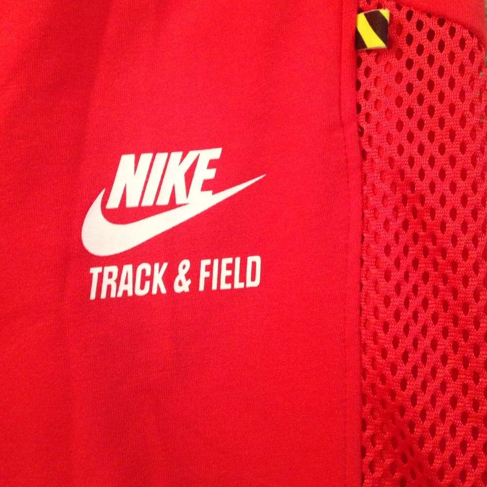 Nike track bottoms with cutout mesh leg strip