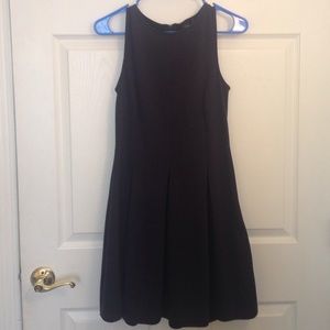 Navy blue, thigh-length, pleated dress.