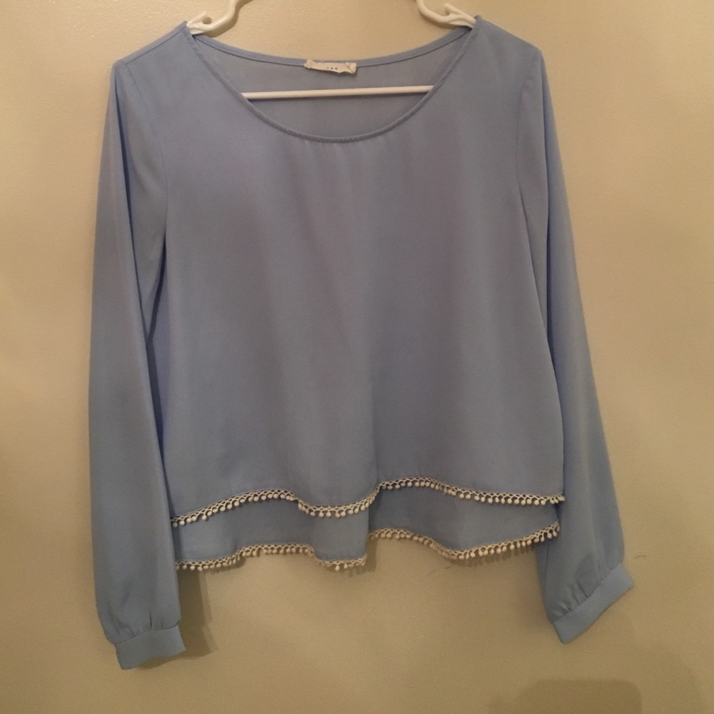 blue shirt with little white pom poms lining
